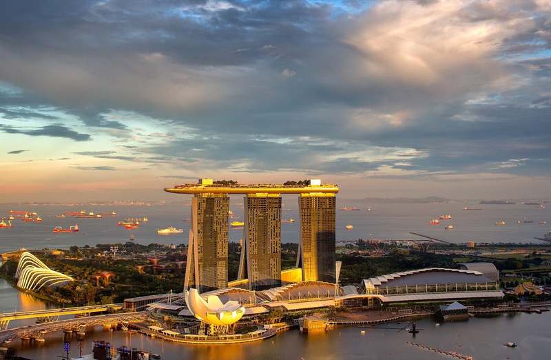 Marina Bay skyline in Singapore at dusk, with Marina Bay Sands and Gardens by the Bay